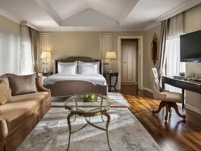 a hotel room with a bed and a couch at Rixos Pera Istanbul in Istanbul