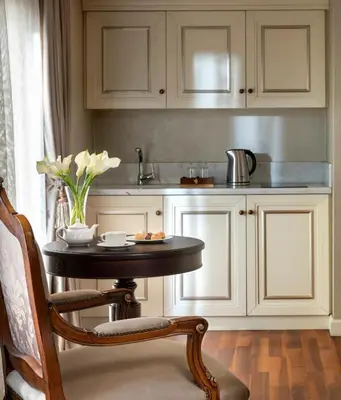 a kitchen with a table with a vase of flowers at Rixos Pera Istanbul in Istanbul