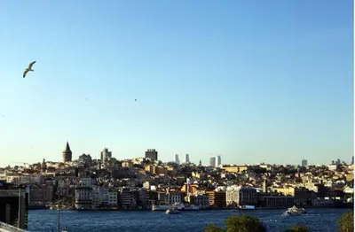 a city skyline with a bird flying over the water at Septimum in Istanbul