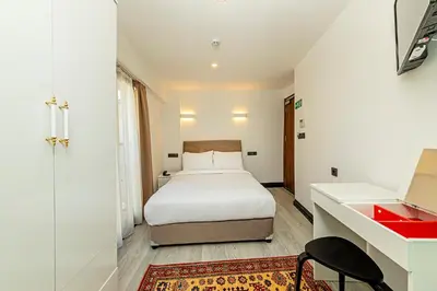 a bedroom with a bed and a desk with a red drawer at Septimum in Istanbul