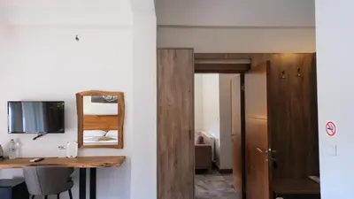 a room with a desk and a mirror and a table at Cevizdibi Hotel in Masukiye