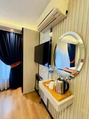 a hotel room with a mirror and a table at Regency World Hotel in Istanbul