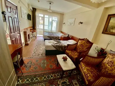 a living room with a couch and a table at Kadikoy Kervansaray Hotel in Istanbul