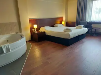 a hotel room with a bed and a bath tub at Tiara Thermal & SPA Hotel in Bursa