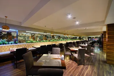 a restaurant with tables and chairs and a bar at Tiara Thermal & SPA Hotel in Bursa