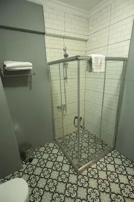 a shower with a glass door in a bathroom at White Pearl Apart Hotel in Istanbul
