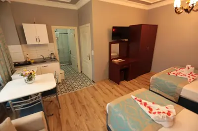 a small room with two beds and a kitchen at White Pearl Apart Hotel in Istanbul
