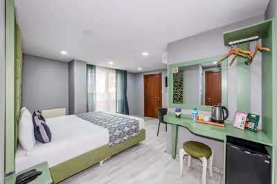 a hotel room with a bed and a desk at Green Garden Hotel - Bahçelievler in Istanbul
