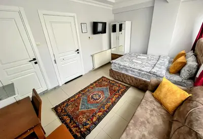 a living room with a couch and a bed at Pembe Hotel in Istanbul