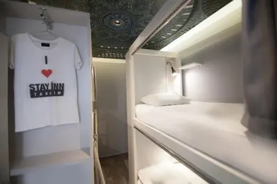 a small room with a shirt hanging on the wall at Stay Inn Taksim Hostel in Istanbul