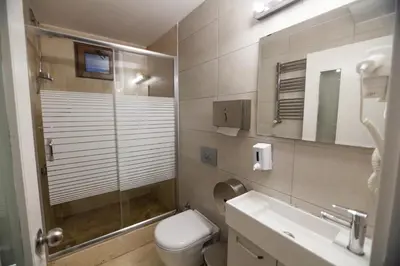 a bathroom with a shower and a toilet and a sink at Stay Inn Taksim Hostel in Istanbul