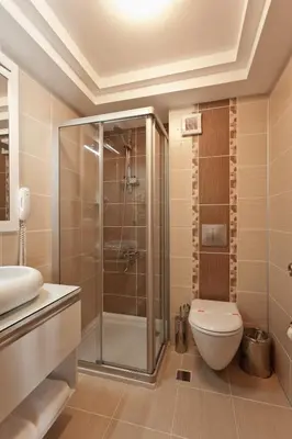 a bathroom with a shower and a toilet and a sink at Mercia Hotels & Resorts in Buyukcekmece