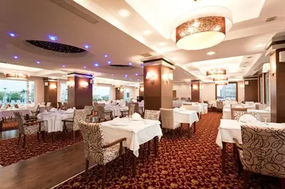 a dining room with white tables and chairs at Mercia Hotels & Resorts in Buyukcekmece