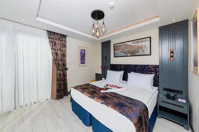 a hotel room with a large bed with flowers on it at The Magnaura Palace Hotel in Istanbul
