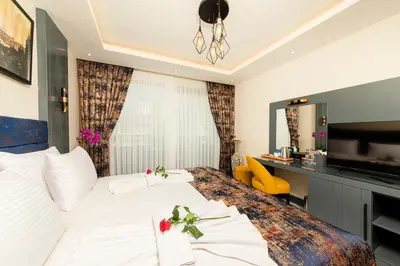 a hotel room with a bed and a television at The Magnaura Palace Hotel in Istanbul