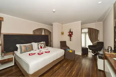a hotel room with a bed with red shoes on it at Darkmen Hotel in Istanbul