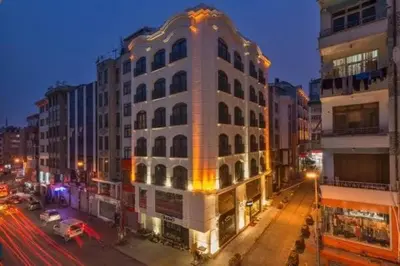 a large white building on a city street at night at Darkmen Hotel in Istanbul