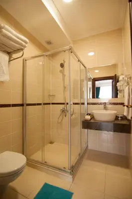 a bathroom with a shower and a toilet and a sink at Akbiyik Suite Boutique Hotel in Istanbul