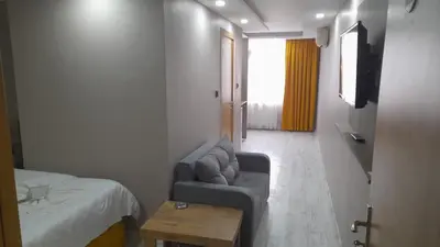 a room with a couch and a bed and a table at Moon Suit Hotel in Istanbul
