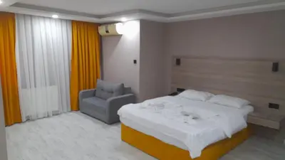 a bedroom with a bed and a chair in it at Moon Suit Hotel in Istanbul