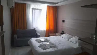 a hotel room with a bed and a chair at Moon Suit Hotel in Istanbul