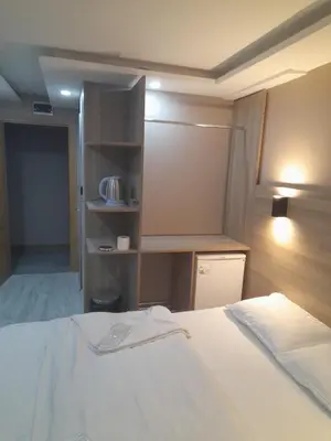 a bedroom with a white bed and a closet at Moon Suit Hotel in Istanbul