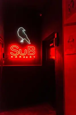 a red neon sign in a dark room at SuB Karakoy - Special Category in Istanbul