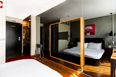 a bedroom with a bed and a mirror at SuB Karakoy - Special Category in Istanbul