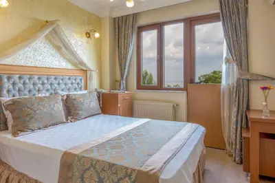 a bedroom with a large bed and a window at Seahouse Suites in Istanbul
