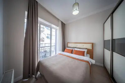 a bedroom with a bed and a large window at Feyza Apart in Istanbul