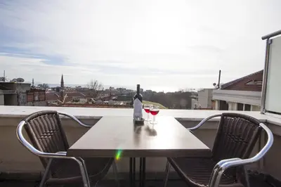 a table with a bottle of wine and two glasses at Feyza Apart in Istanbul