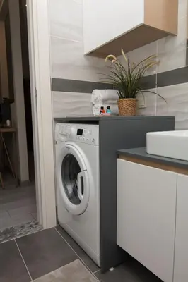a washing machine in a kitchen next to a counter at Zin D Home Otel Alemdağ in Istanbul