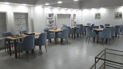 a dining room with tables and blue chairs at Zin D Home Otel Alemdağ in Istanbul