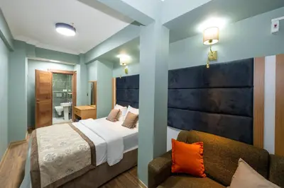 a bedroom with a large bed and a couch at Ista Palace Hotel in Istanbul