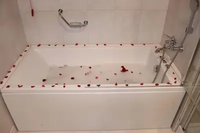 a bath tub with red hearts on the side of it at DES'OTEL in Tekirdag