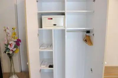 a white refrigerator in a kitchen with a microwave at DES'OTEL in Tekirdag