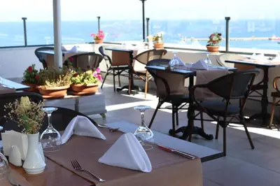 a restaurant with tables and chairs on a balcony at DES'OTEL in Tekirdag
