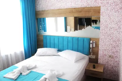 a bedroom with a bed with two towels on it at Hotel Megaron in Istanbul