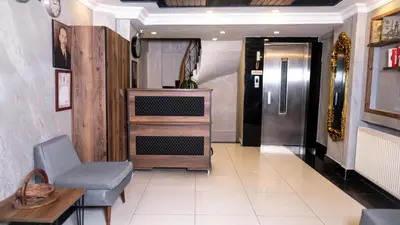a hallway with a chair and a table and a door at Insta Hotel Karakoy in Istanbul