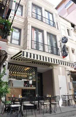a restaurant with tables and chairs in front of a building at Centrum Suites İstanbul in Istanbul