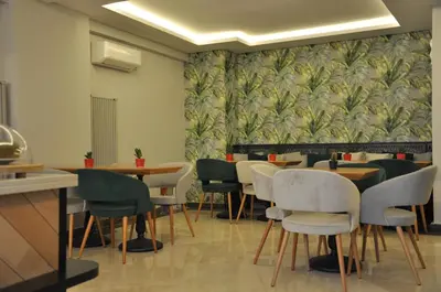 a dining room with tables and chairs and a wallpaper at Centrum Suites İstanbul in Istanbul