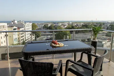 a table and chairs on a balcony with wine glasses at Vatan Asur Hotel in Istanbul