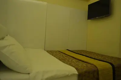 a bedroom with a bed and a tv on the wall at Grand Fatih Hotel in Istanbul