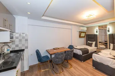 a hotel room with a bed and a table and chairs at T-Square Residence in Istanbul