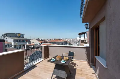 a balcony with a table and a view of a city at T-Square Residence in Istanbul