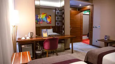 a hotel room with a desk and a bed at Gold Majesty Hotel in Bursa