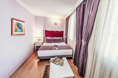 a bedroom with a bed with a red headboard at Olive Garden Apart in Istanbul