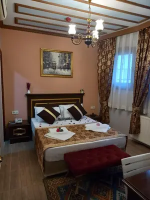 a bedroom with a bed and a chandelier at Emirhan Hotel, Sultanahmet in Istanbul