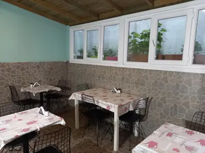 a dining room with tables and chairs and windows at Emirhan Hotel, Sultanahmet in Istanbul