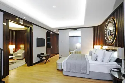 a bedroom with a large bed and a living room at Crowne Plaza Bursa Convention Center & Thermal Spa by IHG in Bursa